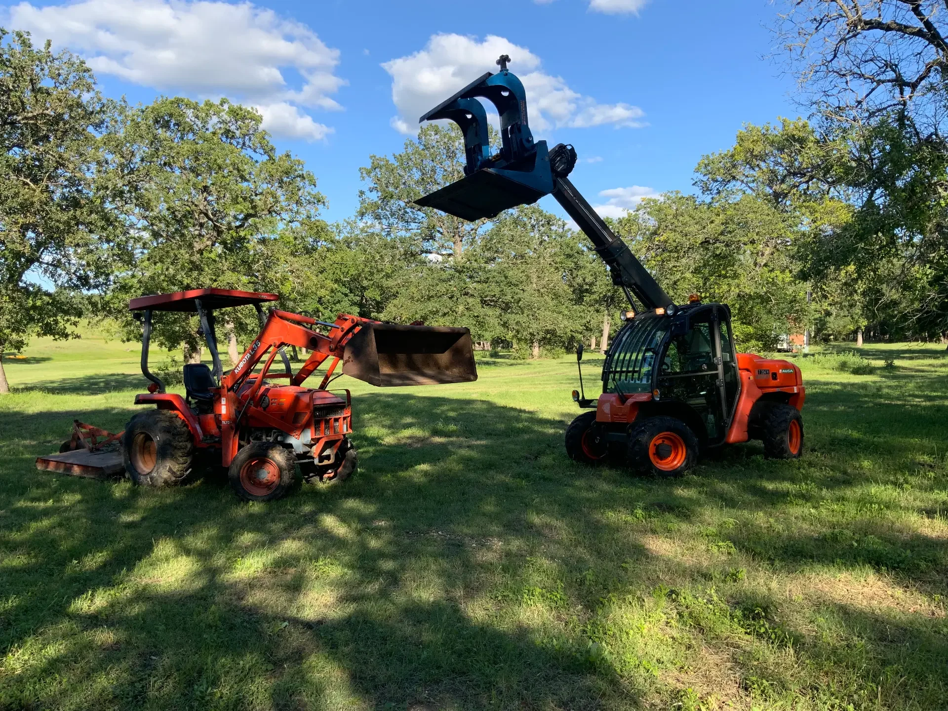 Duke's Kubota tractor and AUSA telehandler clearing brush and trees for land clearing and lot prep in Austin, TX