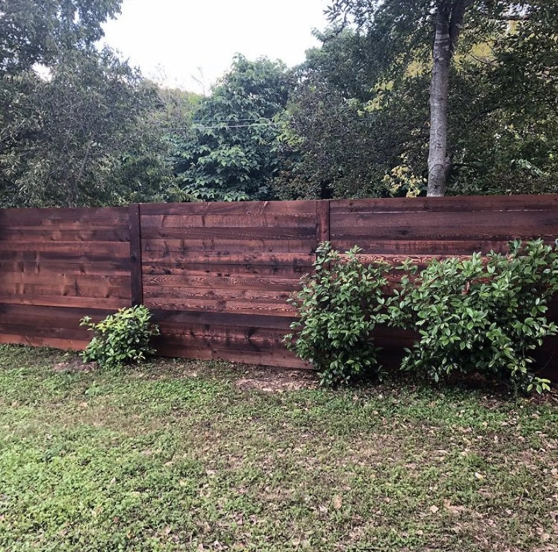 Stained wood privacy fence built by Duke's fence installation crew in Central Texas