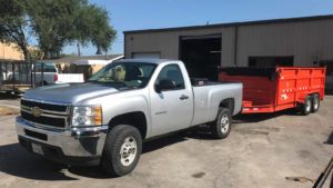 Junk removal in Austin with a truck and trailer offering junk hauling to Duke's Junk Recycling